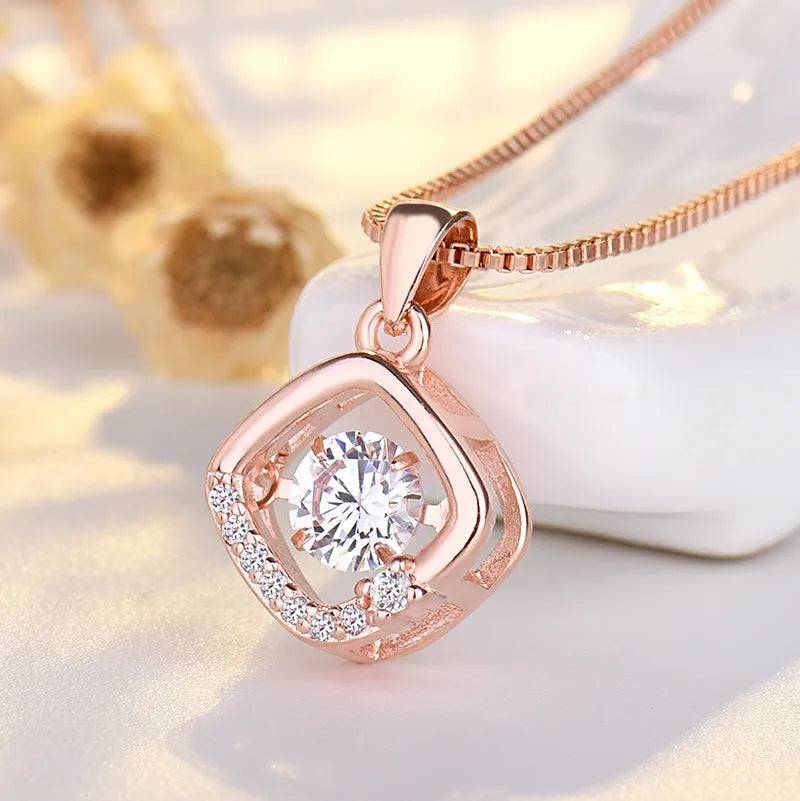 Women's silver heart-shaped necklace pendant featuring a crown and bow design on an adjustable chain.