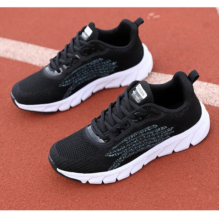 Women's black and white low-top running sneakers with cross strap design and MD soles