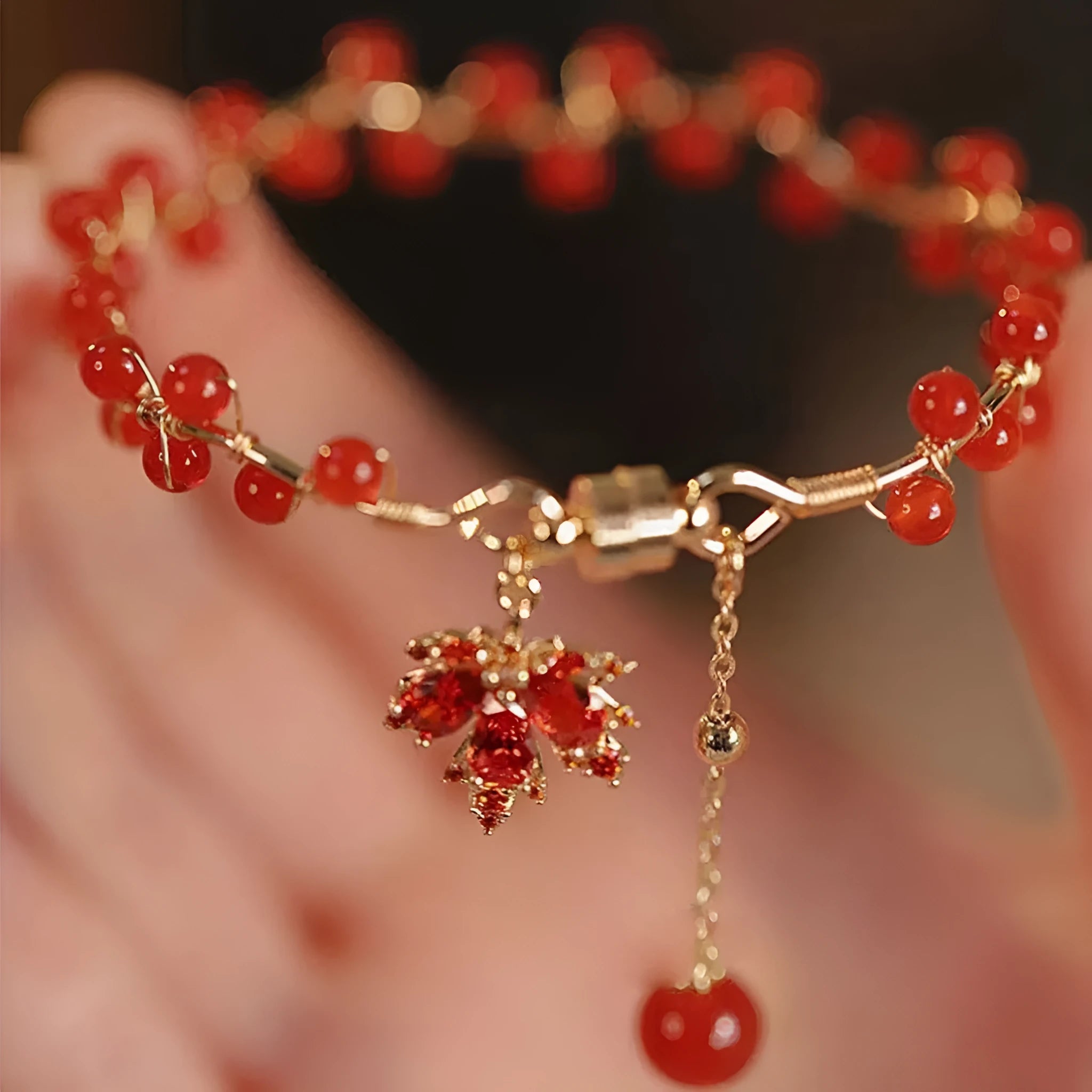 Red ginkgo leaf charm on an alloy magnetic bracelet with Chinese style design.
