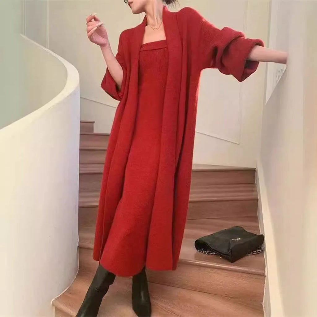 Woman wearing a grey textured flecked long-sleeve dress with a matching open cardigan from a two-piece knit set.