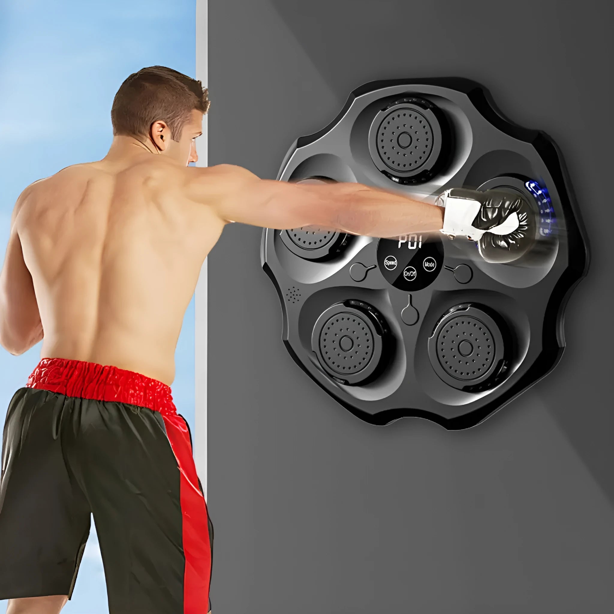 Black Bluetooth music boxing wall target hanging on a wall with an adult boxing glove.
