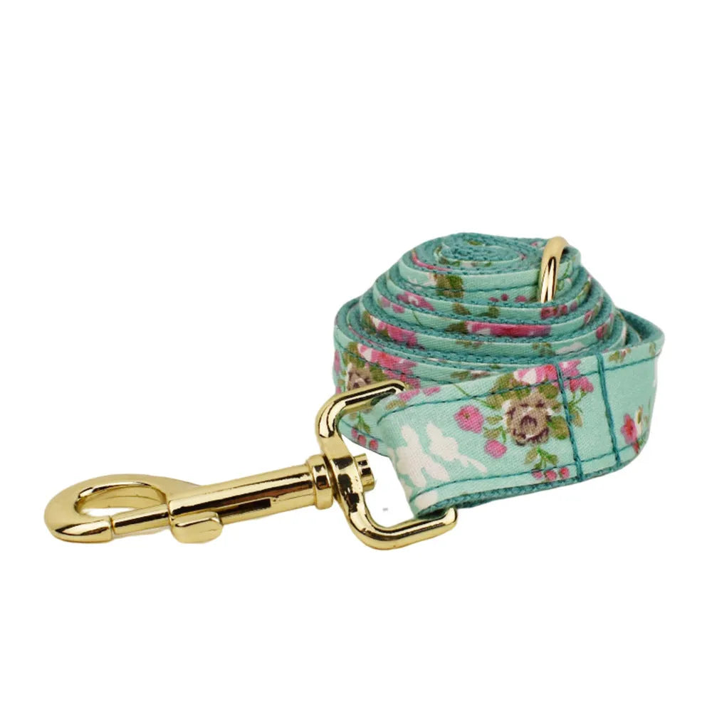 Rose pattern fabric dog collar set with green background, matching leash, detachable bow and coordinating dog vest
