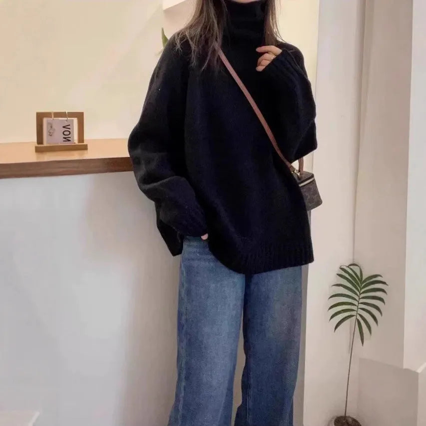Women's loose fit turtleneck sweater with a thick, textured curling pile collar in a solid colour.