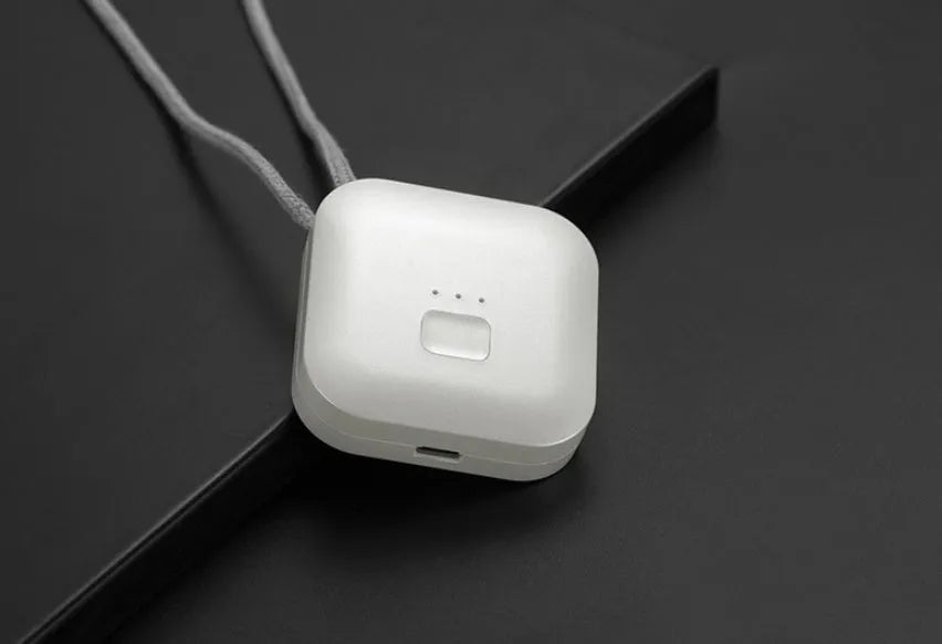 Compact USB-powered air purifier necklace in pink, showing wearable design and one-button control.