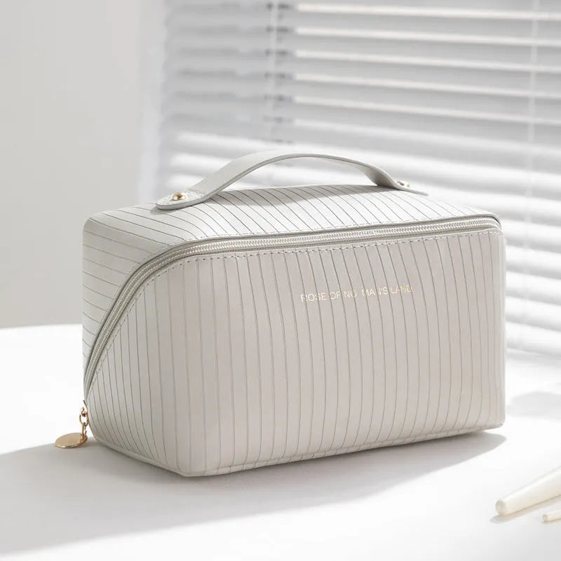 Large beige cubic PU leather makeup bag with vertical pattern, shown open.