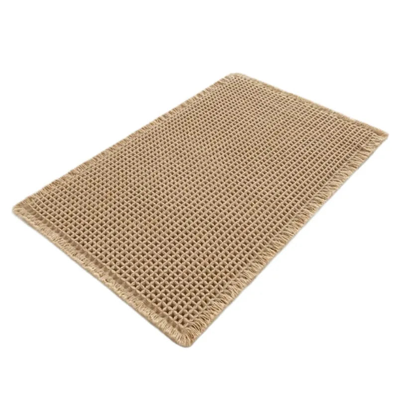 A beige checkered non-slip polyester bathroom carpet on a tiled floor.