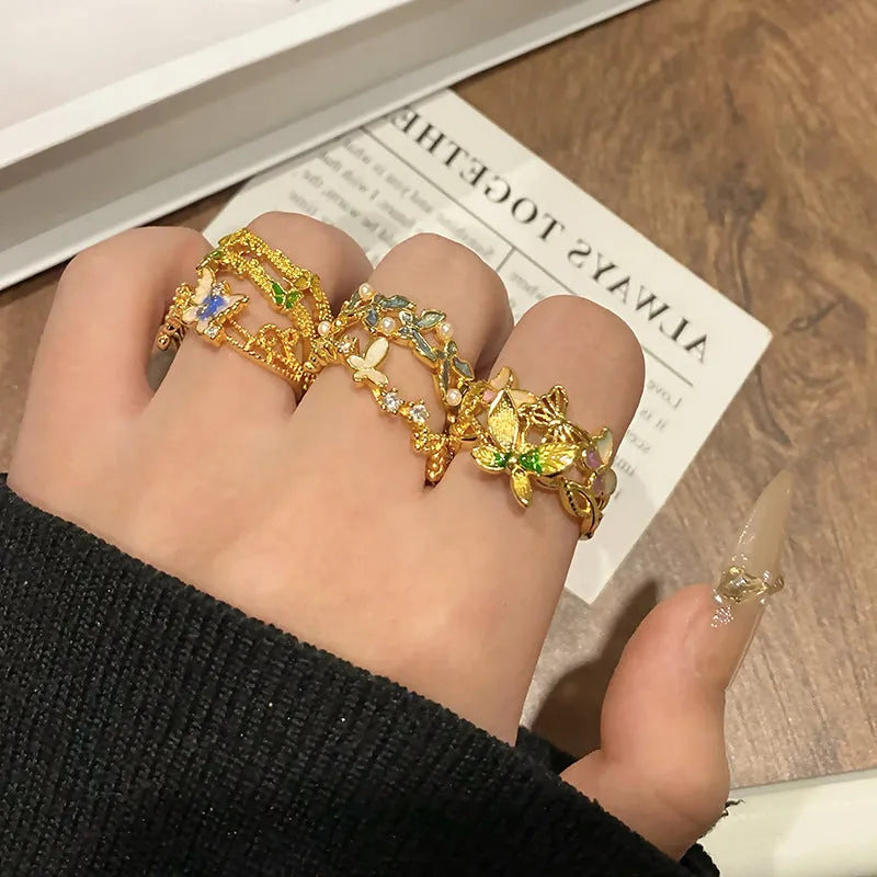 A copper women's ring with a butterfly design and a unique dripping oil textured finish.