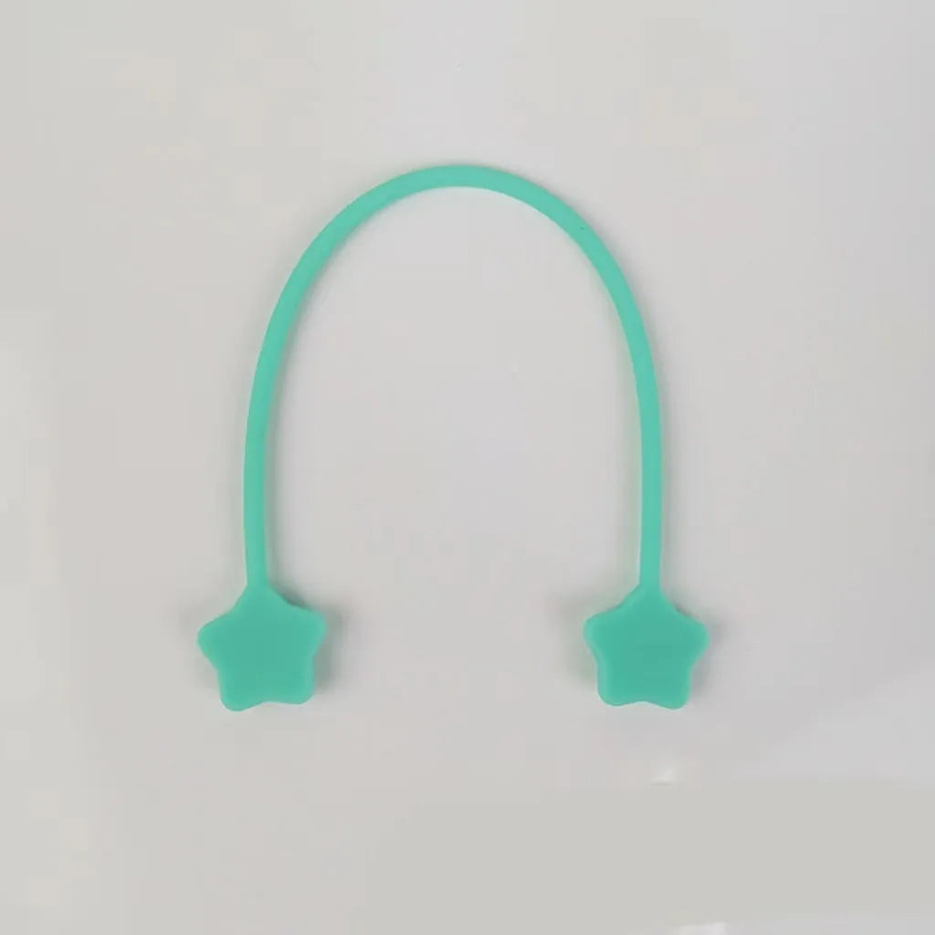 Silicone cable winder organiser with magnet in assorted colours on a table.