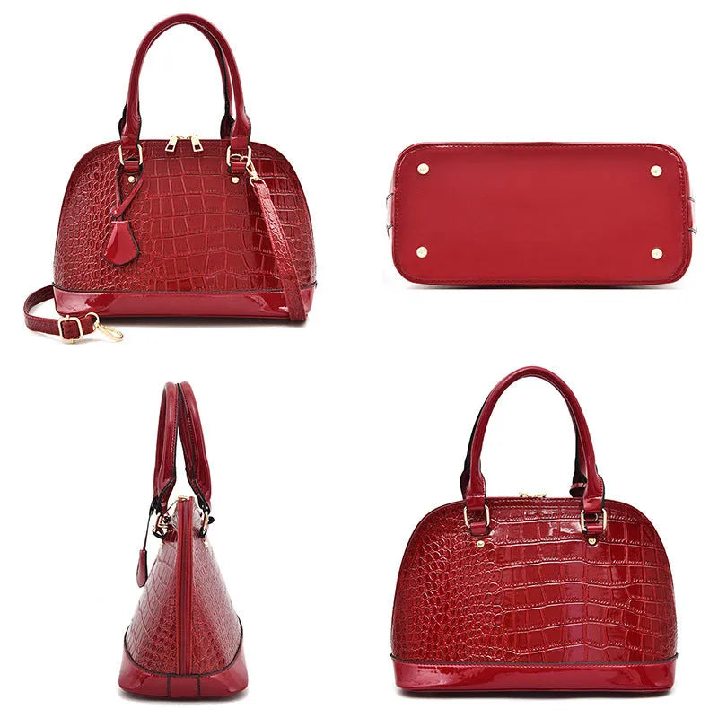 Women's large shiny PU leather crossbody shoulder bag in shell shape, shown in black colour.