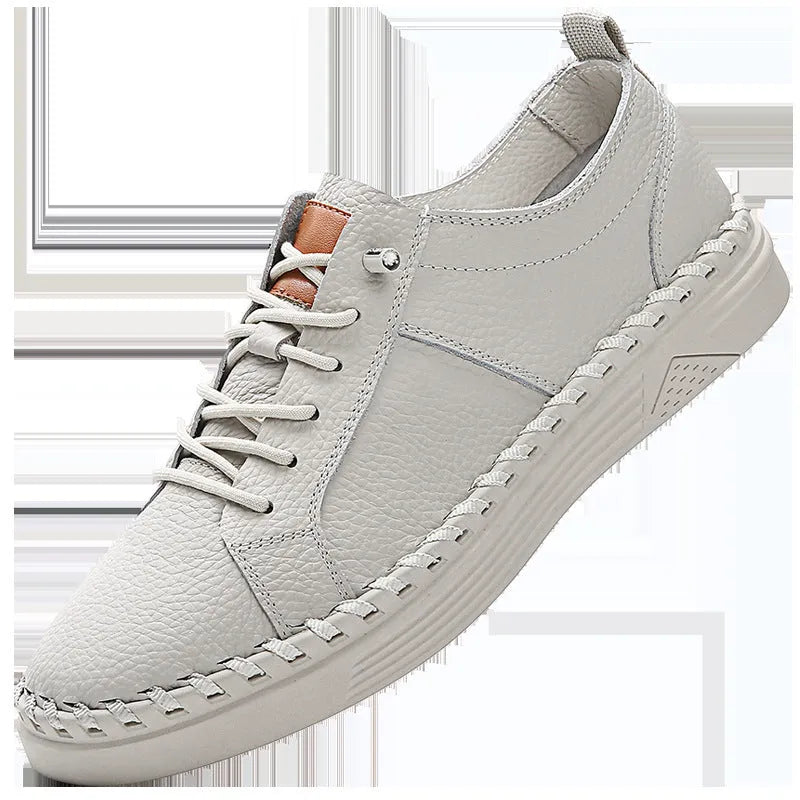 Men's beige and black cowhide leather sneakers with round toe and visible stitching on a white background.