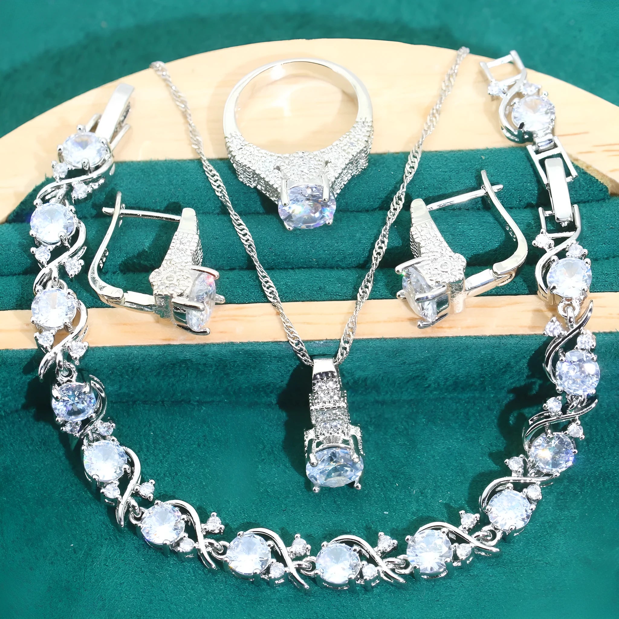 Four-piece bridal jewellery set showing necklace, bracelet, earrings and ring with alloy pendant and water wave chain