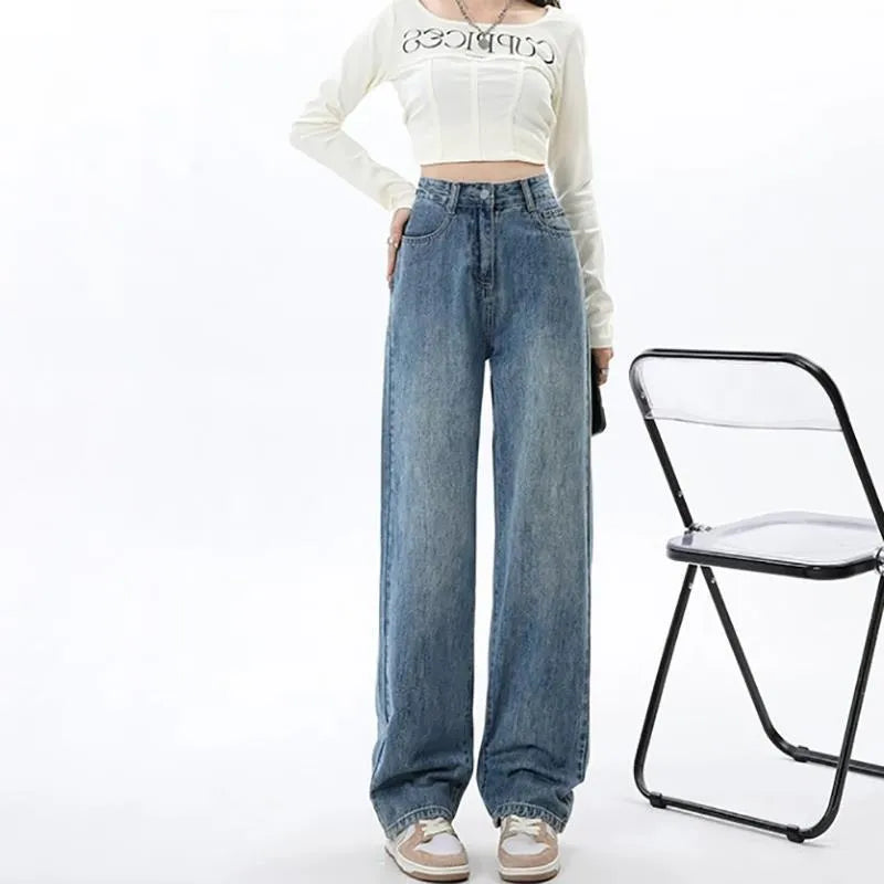 Woman wearing retro blue high-waist wide leg denim jeans with a relaxed fit.
