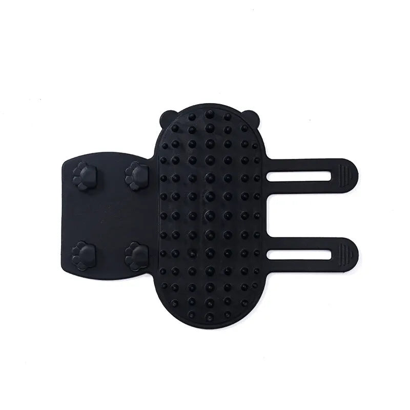Silicone cat grooming comb with rounded teeth and adjustable strap mounted on a table leg.
