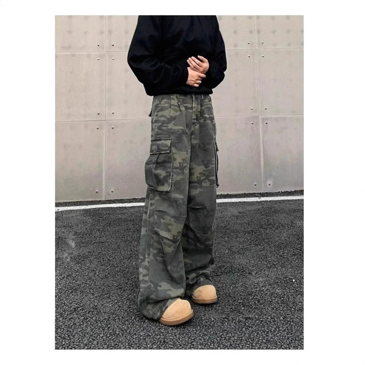 Men's olive and brown washed camouflage cargo trousers with multiple pockets on the thighs and sides.