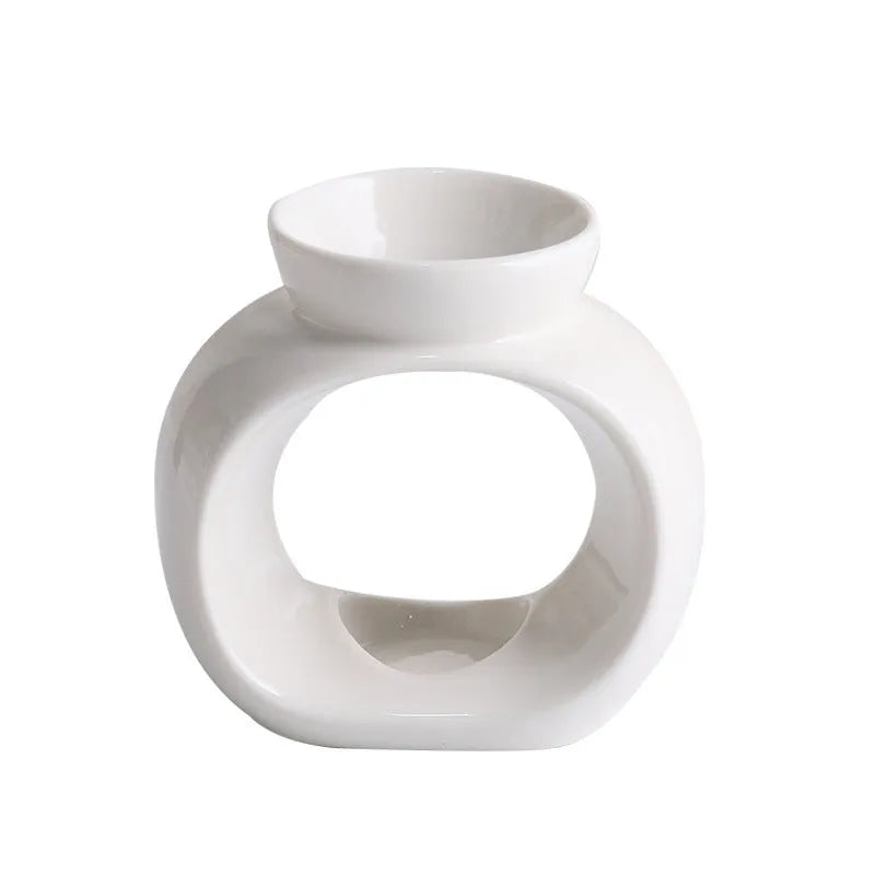 White retro Nordic ceramic aromatherapy stove ornament on a surface.