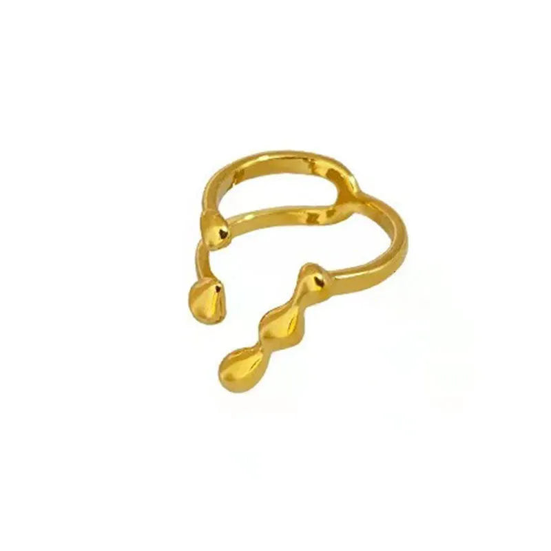 Gold brass opening ring with sphere design on a white background.