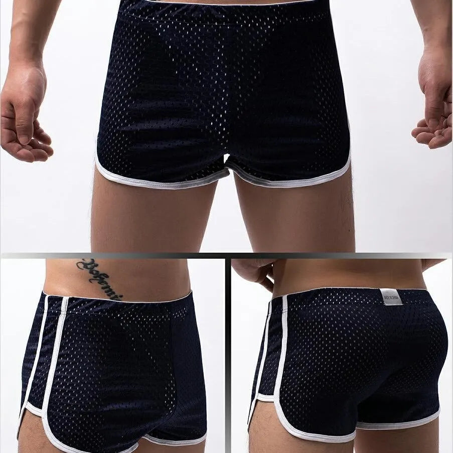 Men's cotton three-point boxer shorts in light blue, laid flat to show mid-waist design and trunk style.