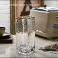Set of three transparent gold-painted glass vases in 8x20CM, 8x25CM, and 8x30CM on a table