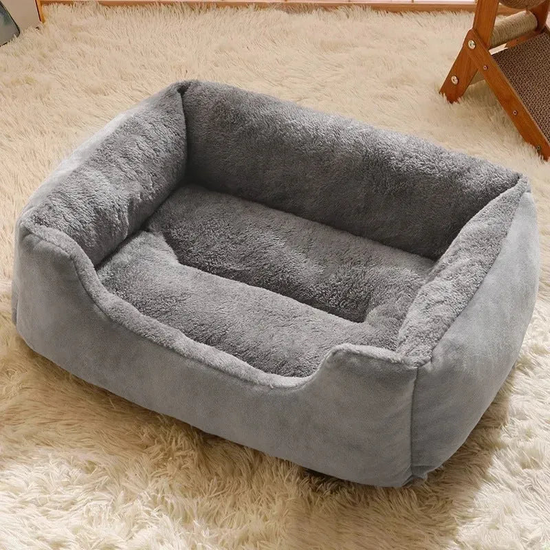 Soft short plush pet bed for cats and dogs in grey, shown in a large size on a wooden floor.