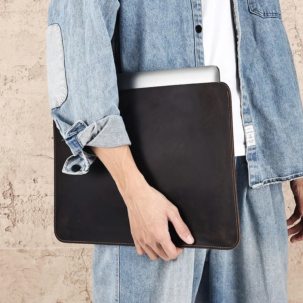 Brown genuine leather horizontal computer bag liner organiser with a laptop inside