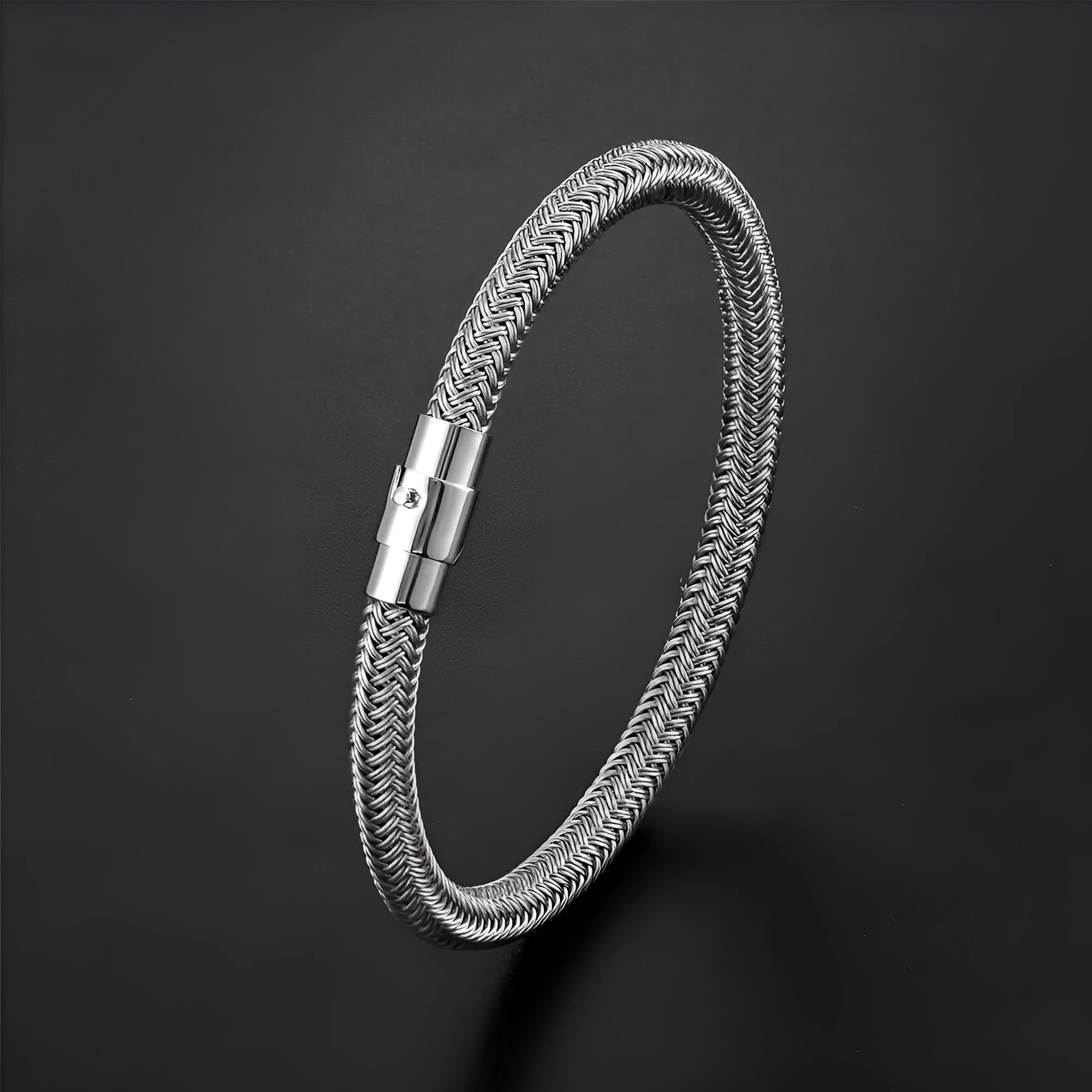 Geometric titanium steel wire bracelet with a magnetic clasp on a wrist, shown in a silver-toned finish.
