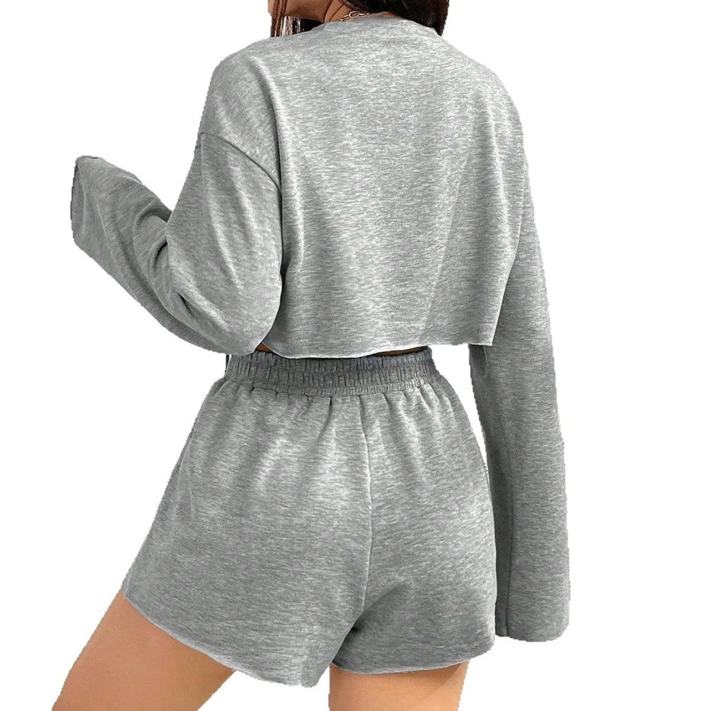 Grey women's long-sleeved T-shirt and matching shorts sleepwear set laid flat