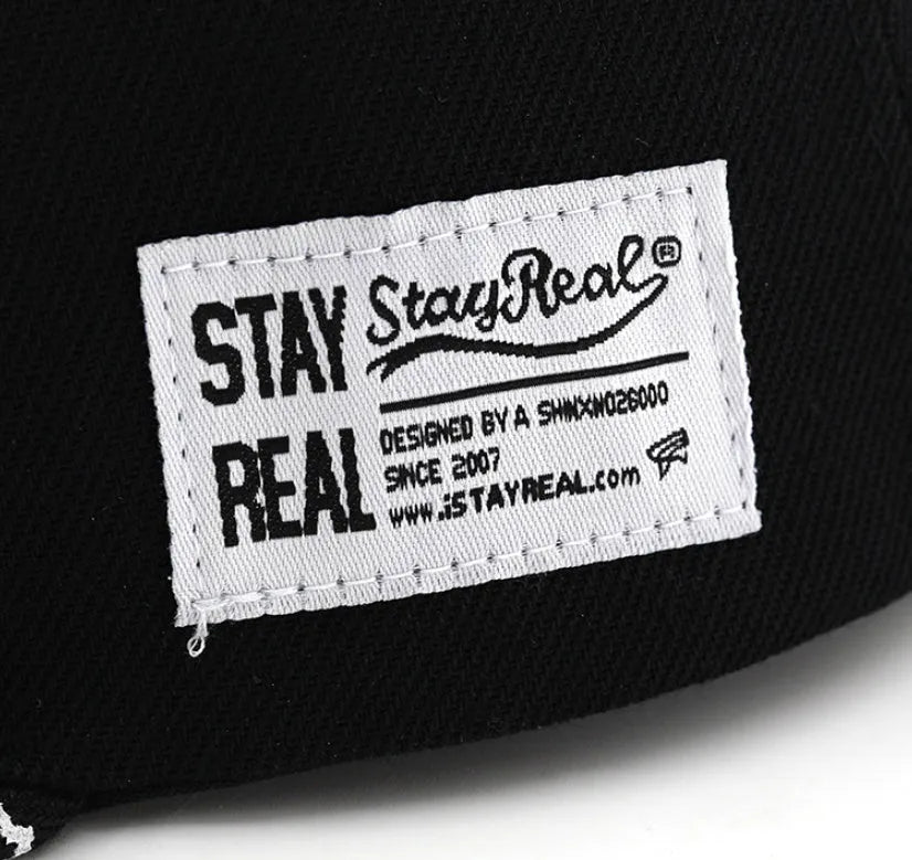 SR Black cotton baseball cap with front letter embroidery, showing adjustable snapback strap and dome crown.