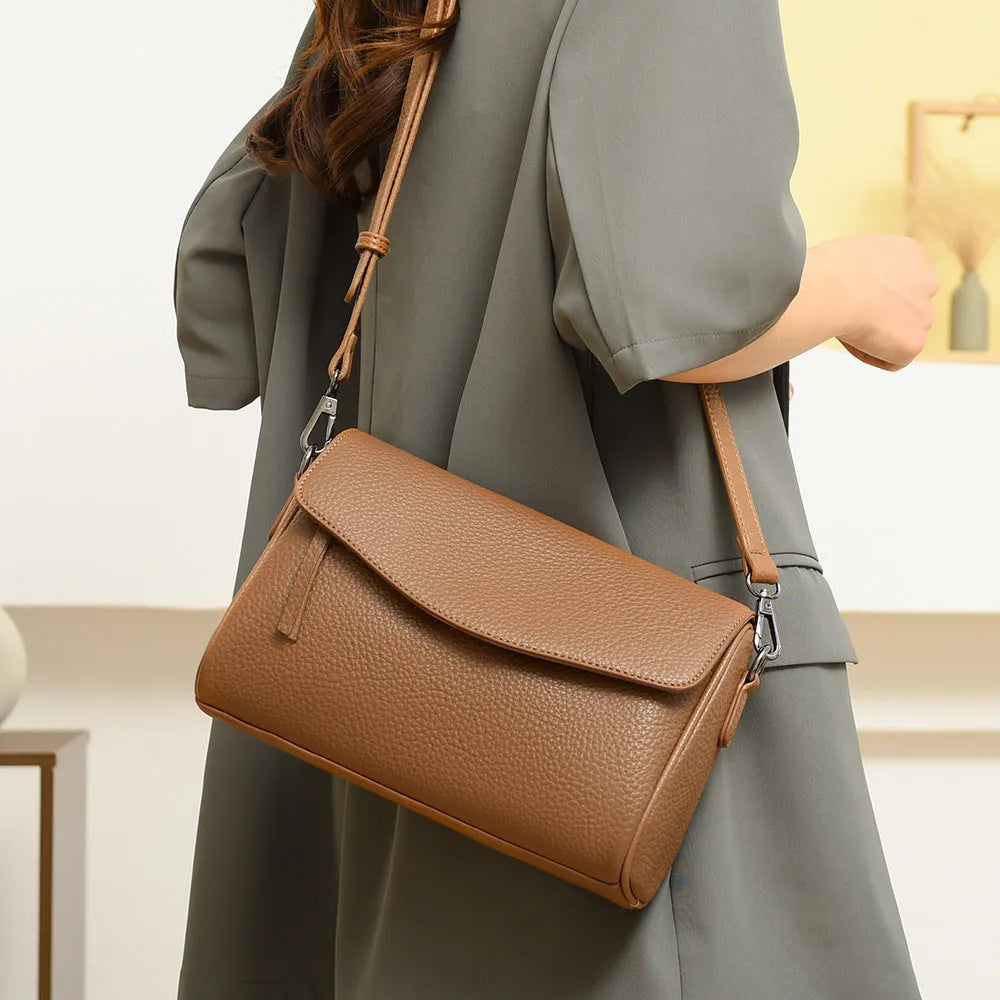 Casual simple women's shoulder messenger bag in black genuine leather with double shoulder straps and lined interior.