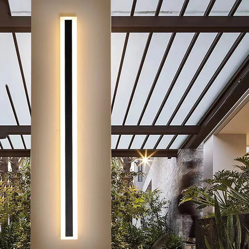 Outdoor waterproof LED wall lamp with linear design and IP65 rating on a wall.
