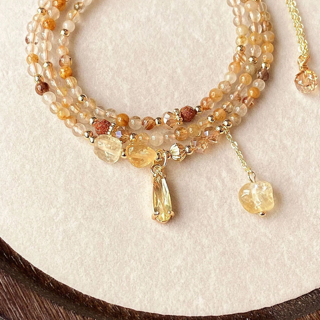 Gold multi-layer bracelet with citrine crystals and three-circle Saturn design