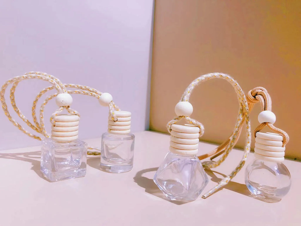 Car air vent perfume pendant showing cylinder, diamond, flat drum, and square glass bottle designs
