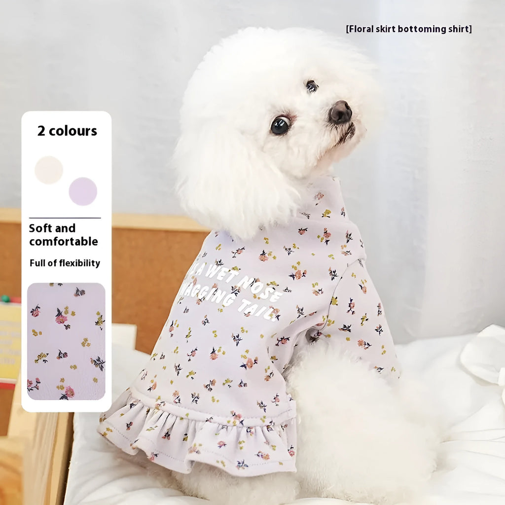Teddy bichon dog wearing light purple undershirt and matching floral skirt pet clothing