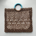 Dark brown handmade straw tote bag with square vertical shape and sandwich pocket design
