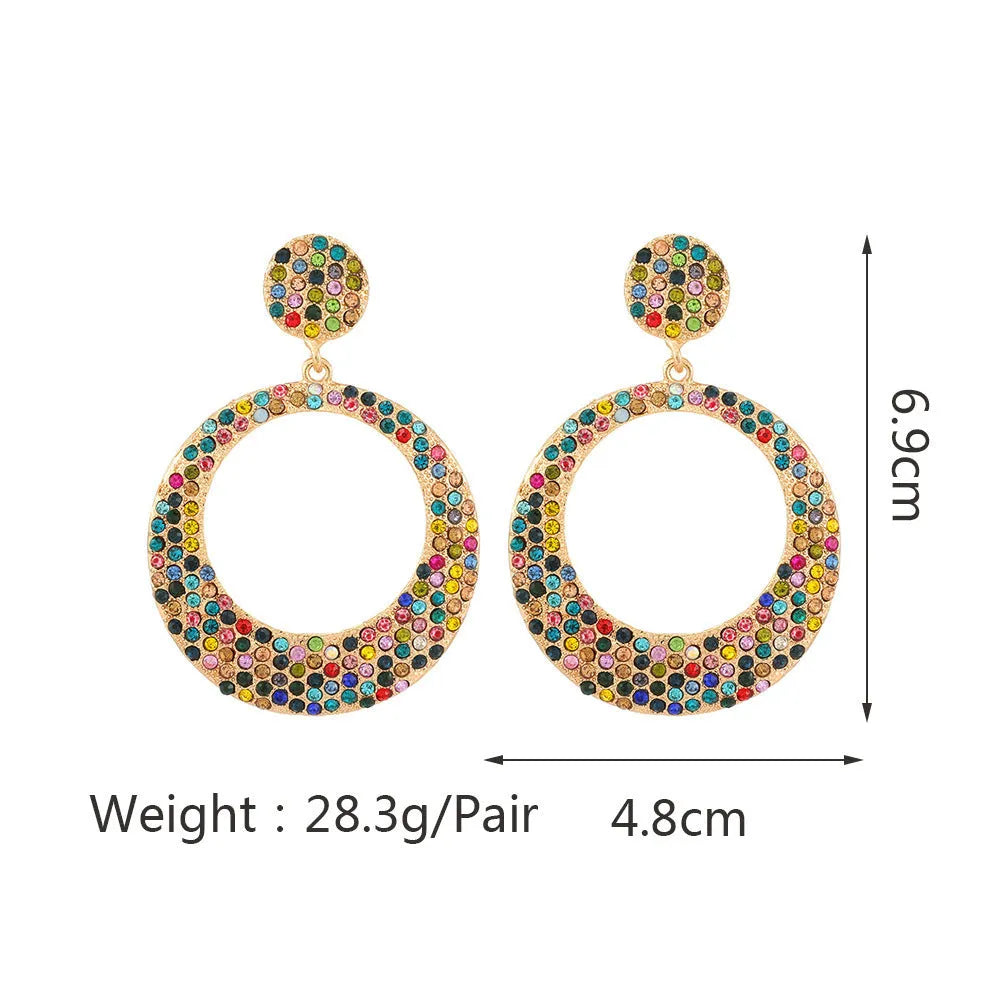 A pair of large round pendant earrings with a cartoon style in a colour metal alloy finish.