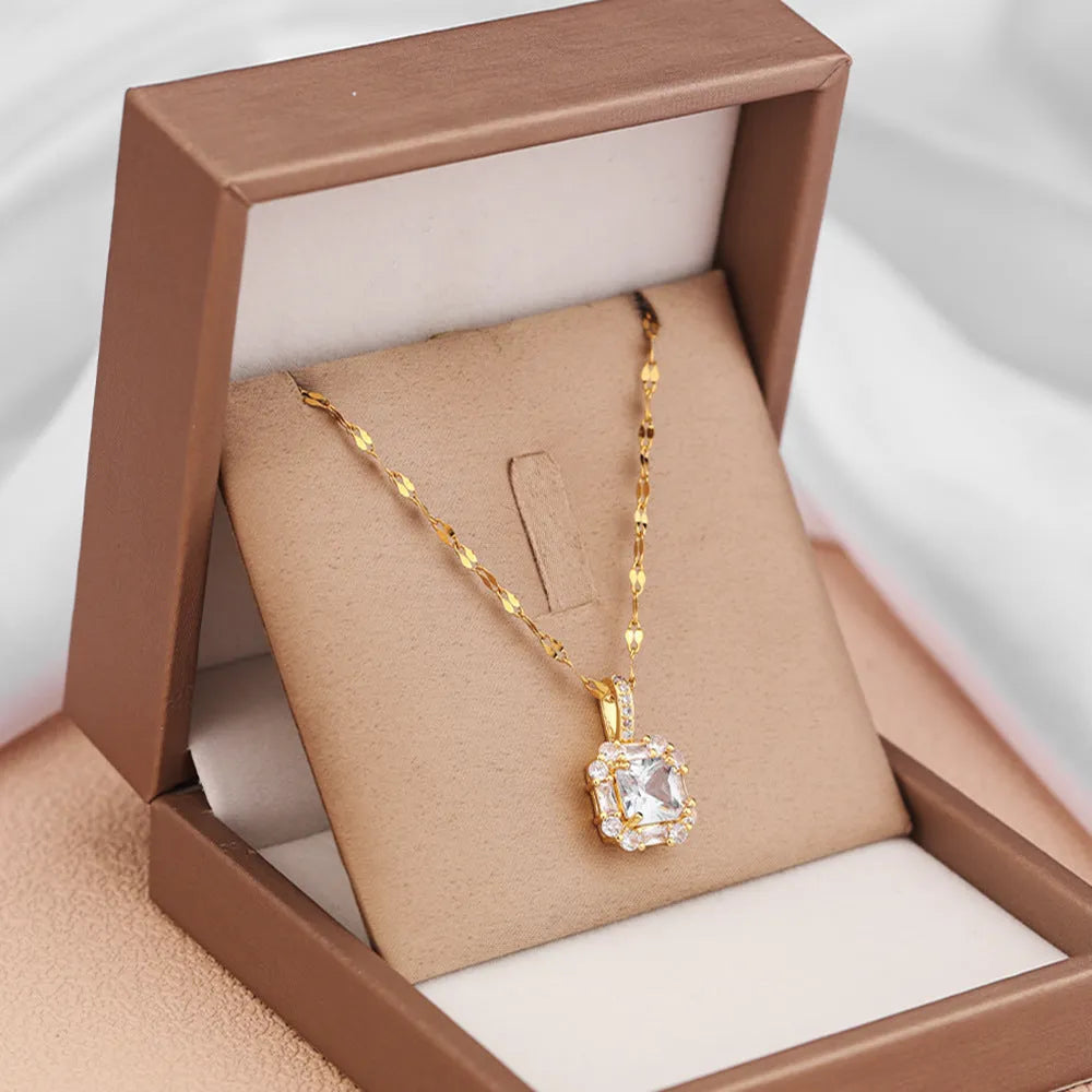 Geometric quadrilateral pendant necklace with mixed gem inlay on a gold titanium steel chain.
