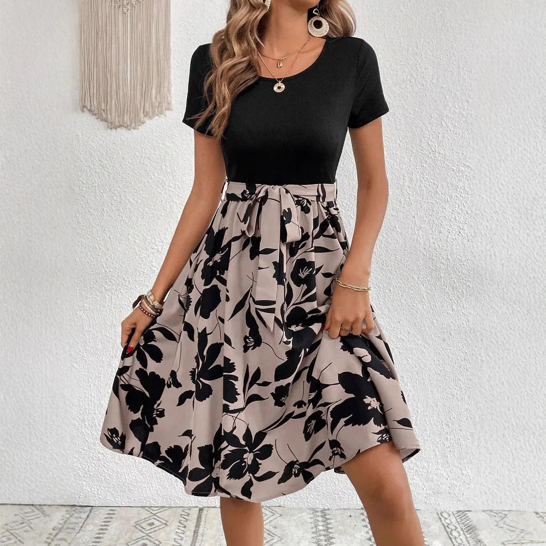 Women's khaki floral print A-line dress with lace-up shoulder straps on a hanger.