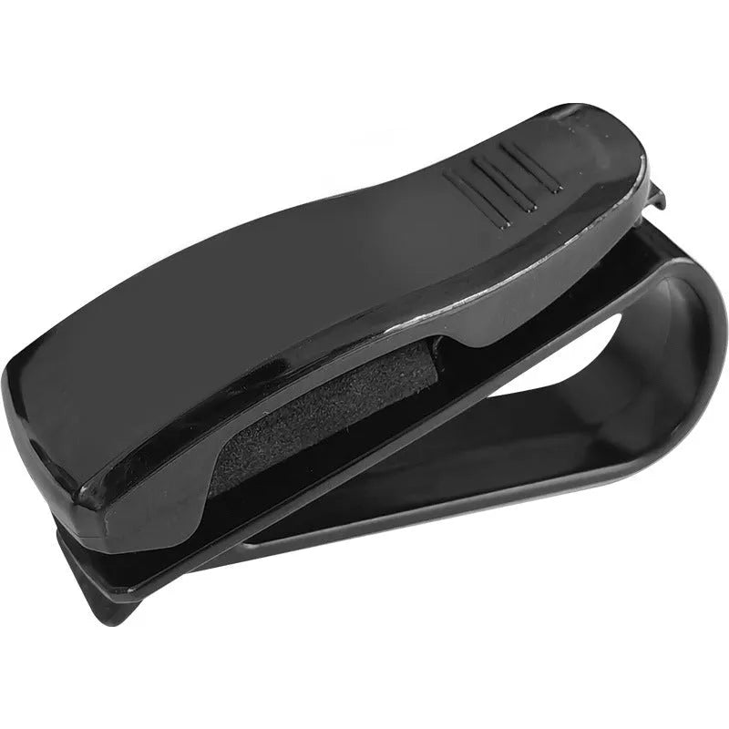 Black plastic car sunshade clip for holding glasses and cards, measuring 6.5 by 2.3 centimetres.