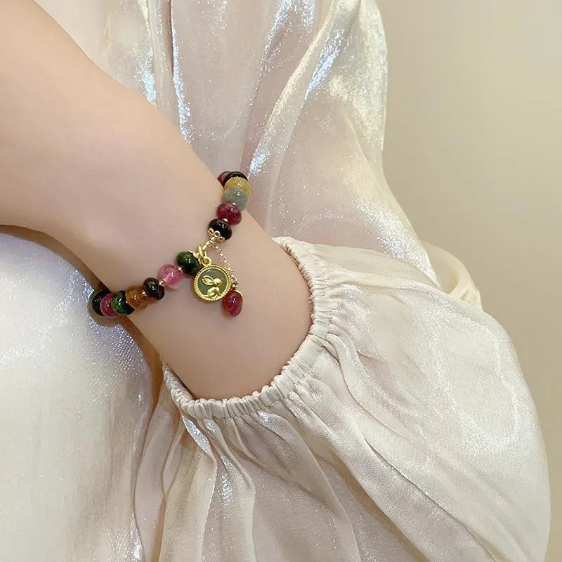Colourful tourmaline rabbit pendant on a natural stone abacus bead bracelet.