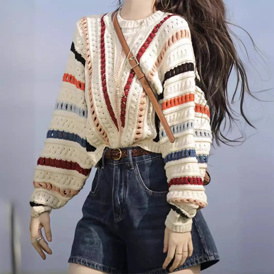 Multicolour rainbow striped women's sweater with batwing sleeves and a loose round neck fit.