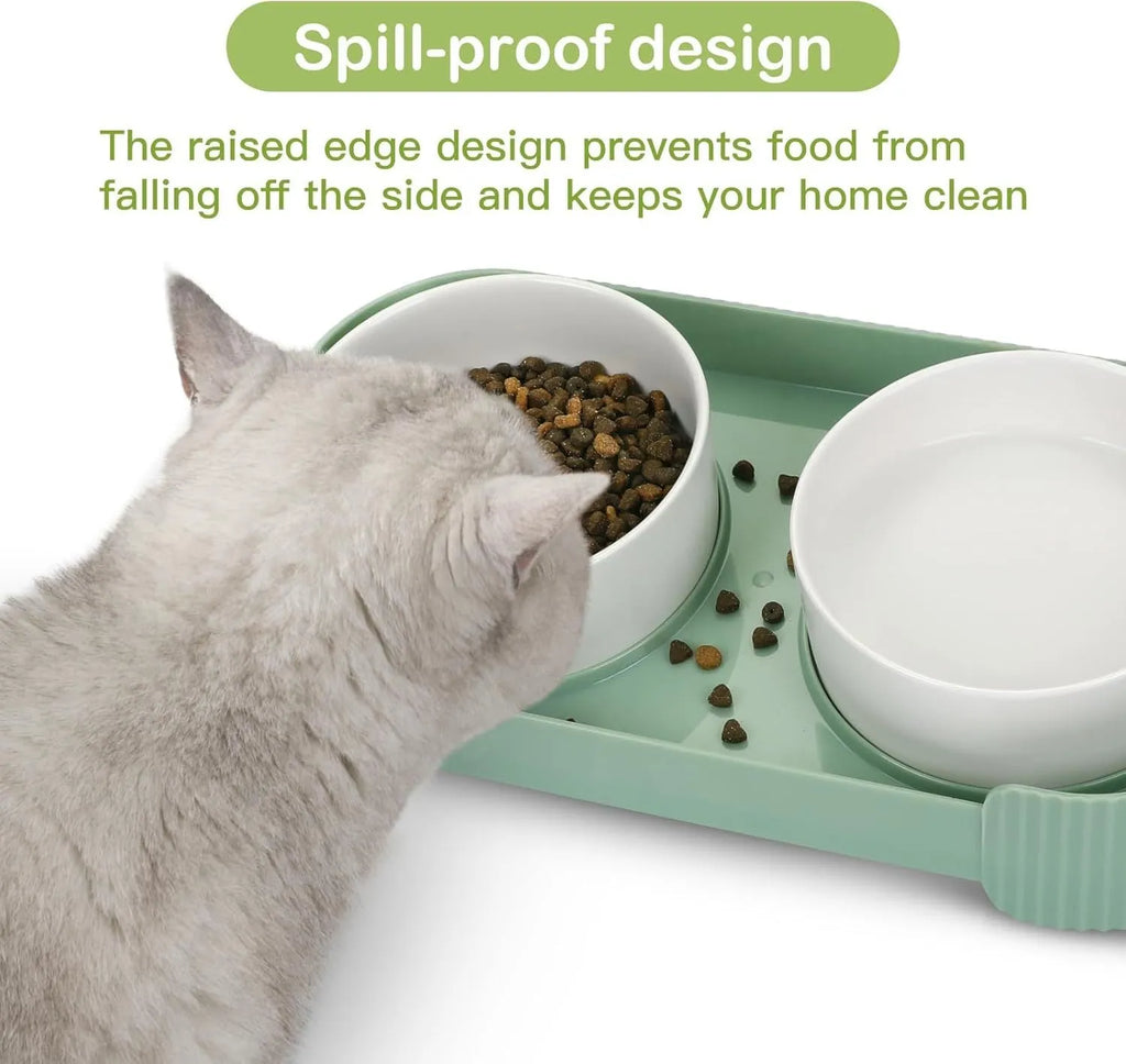 Green ceramic elevated cat feeder with two tilted bowls on a non-slip stand