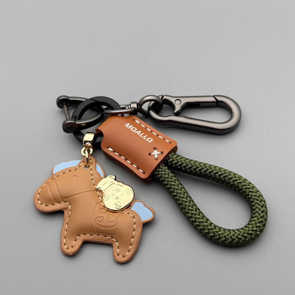 Handmade brown cowhide key ring pendant with a zinc alloy pony belt buckle and green flanelle rope.