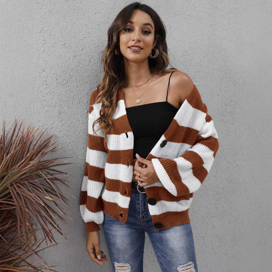 Blue striped women's cardigan sweater with buttons, shown on a hanger.
