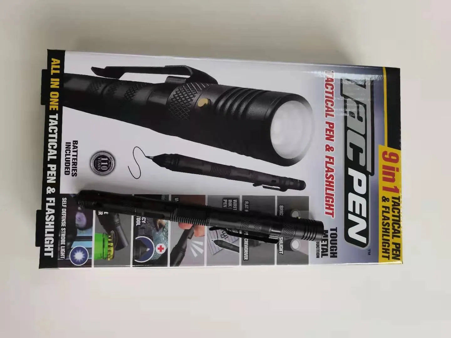 Black multi-function survival pen with built-in LED flashlight and pointed steel window breaker tip.