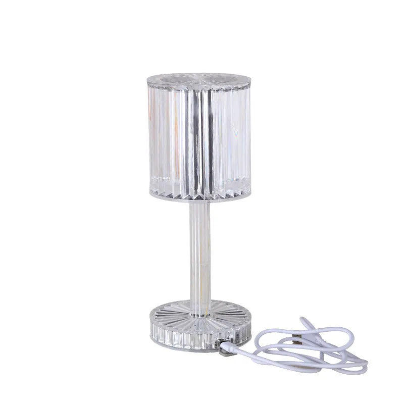 Modern crystal table lamp with transparent bead shade and metal stand on wooden surface