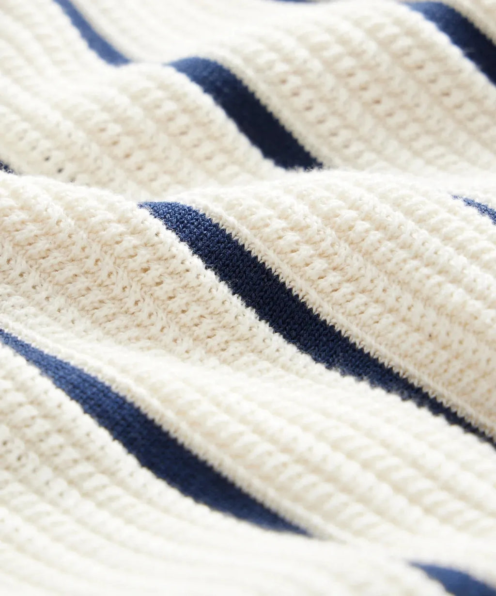 Men's white asymmetric lapel short sleeve knitted top laid flat, showcasing ice silk fabric texture.