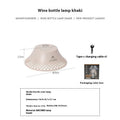Beige fabric shade camping lantern on wooden table, powered by a repurposed wine bottle base with USB-C port.
