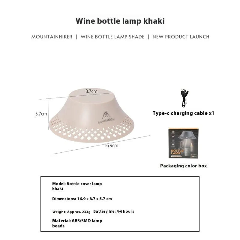 Beige fabric shade camping lantern on wooden table, powered by a repurposed wine bottle base with USB-C port.