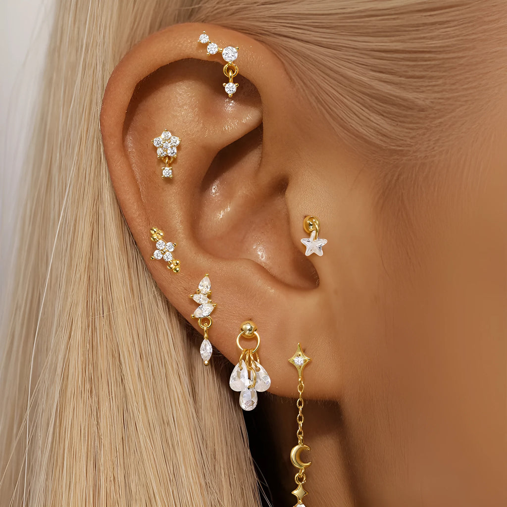 S925 sterling silver geometric moon and star earrings with diamond accents on a gold-coloured background.