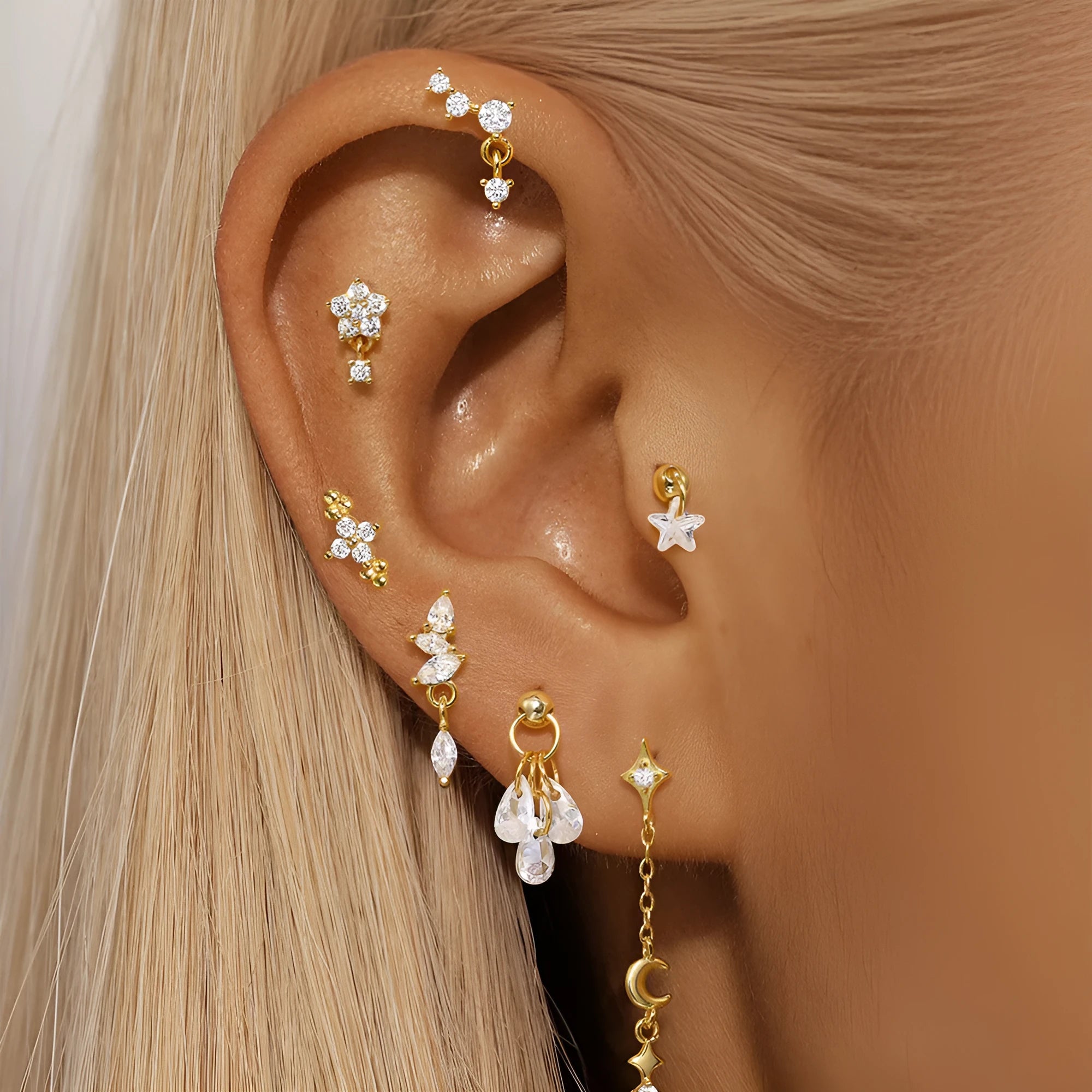 S925 sterling silver geometric moon and star earrings with diamond accents on a gold-coloured background.
