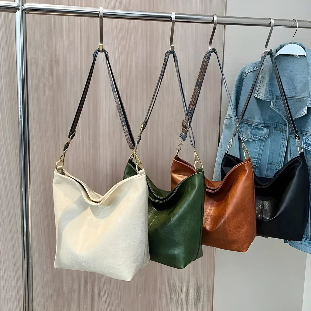 Women's large capacity crossbody bucket bag in PU with nylon lining, available in multiple colours, includes zipper change bag and phone pocket